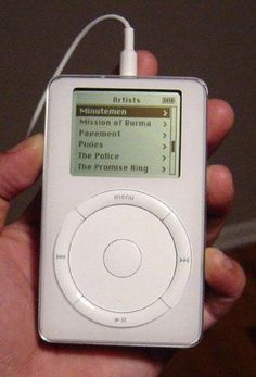 a person holding an ipod in their left hand and listening to music on the other