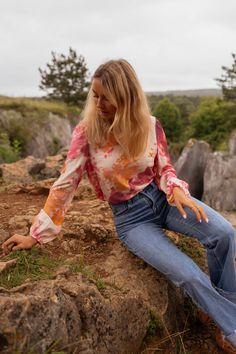 Easily adjust and tie the open back with a drawstring for a customizable look. The vibrant orange patterns add a touch of fun and playfulness to this crewneck blouse with long sleeves. The elastic wrists provide a comfortable fit while the blouse remains unlined and not sheer. Ophelie is also wearing the Blue Maddie Jeans Sizes: S-M / M-L S-M: Length 21.3 in - Width 18.1 in M-L: Length 22.0 in - Width 18.9 in 40% Viscose - 20% Polyamide Washing: handwash Orange Long Sleeve Blouse With Relaxed Fit, Orange Relaxed Fit Long Sleeve Blouse, Casual Long Sleeve Blouse With Elastic Sleeves, Casual Long Sleeve Tops With Elastic Sleeves, Pink Long Sleeve Tops With Elastic Sleeves, Casual Orange Stretch Blouse, Casual Stretch Orange Blouse, Multicolor Blouson Sleeves Top For Fall, Casual Pink Tops With Elastic Sleeves