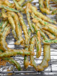 some fried green beans on a metal rack