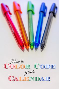 four different colored pens sitting next to each other on top of a white sheet with the words how to color code your calendar