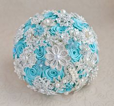 a bridal bouquet with blue roses and pearls