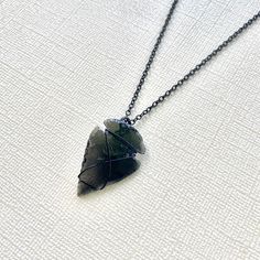 This obsidian arrowhead necklace is a perfect choice for those seeking unique spiritual jewelry. Additionally, these pieces serve as meaningful gifts for her and him, and reflect the rich heritage of the Native American culture. 🪶 𝗠𝗔𝗧𝗘𝗥𝗜𝗔𝗟𝗦 + 𝗗𝗜𝗠𝗘𝗡𝗦𝗜𝗢𝗡𝗦 ❯  Arrowhead measures approximately 1 to 1-1/4 inches long ❯  Black metal (nickel-free) chain + matching lobster claw clasp 🪶 𝗦𝗧𝗢𝗡𝗘 + 𝗘𝗟𝗘𝗠𝗘𝗡𝗧 𝗘𝗡𝗘𝗥𝗚𝗬 ❯  BLACK OBSIDIAN is the stone of truth and integrity 🪶 𝗛𝗢𝗪 𝗧𝗢 𝗢𝗥𝗗𝗘𝗥 1.   Select the length + style option 2.  Type in text in the personalization section (if you are selecting an engraved charm) 3.  Add to cart 4.  Select desired shipping method 🪶 𝗣𝗘𝗥𝗦𝗢𝗡𝗔𝗟𝗜𝗭𝗔𝗧𝗜𝗢𝗡 ❯  Add a custom engraved charm by selecting a font (photo 5) and t Handmade Black Arrowhead Jewelry, Handmade Black Arrowhead Necklace, Bohemian Arrowhead Jewelry As A Gift, Bohemian Arrowhead Jewelry As Gift, Bohemian Arrowhead Jewelry Gift, Arrowhead Wire Wrapped Necklaces For Gifts, Wire Wrapped Arrowhead Necklace For Gift, Spiritual Arrowhead Necklace Gift, Obsidian Arrowhead