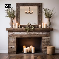 candles are lit in front of a fireplace with a mirror on the wall above it