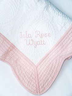 a pink and white quilted blanket with the words, leta rose uyiyatt on it