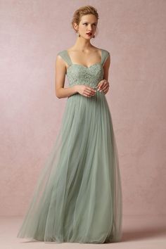 a website page for a bridesmaid and bridal gown store, with an image of a woman in a green dress