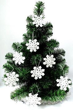 a small christmas tree with snowflakes on it