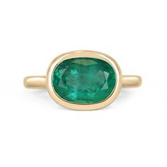 Displayed is a medium-dark green Colombian emerald, solitaire, oval cut bezel ring in 14K yellow gold. This gorgeous solitaire ring carries a full 2.68-carat emerald in a sleek bezel setting. The emerald has incredible clarity and luster. This emerald has a great spread along with unique clarity that will have you captivated at first glance. This is an ideal engagement ring or right-hand ring! Setting Style: Solitaire / Bezel Setting Material: 14K Yellow Gold Gold Weight: 4.1 Grams Main Stone: E Green Emerald Ring With Oval Cabochon Bezel Setting, Emerald Bezel Set Oval Cabochon Ring, Oval Polished Emerald Ring In 14k Gold, Oval Emerald Ring With Polished Finish In 14k Gold, Oval Emerald Ring In 14k Gold With Polished Finish, Oval Emerald Ring With Bezel Setting, Modern Oval Green Jewelry, Oval 14k Gold Emerald Ring, Oval Emerald Ring With Polished Finish In Yellow Gold