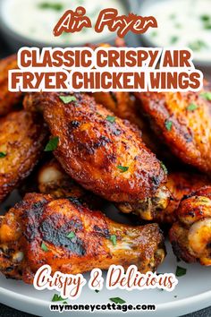 chicken wings on a plate with ranch dressing in the background and text classic crispy air fryer chicken wings