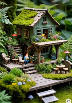 a miniature garden with a little house in the middle