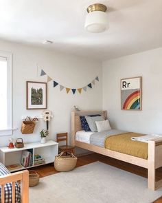 a bedroom with a bed, desk and bookshelf on the floor in front of a window