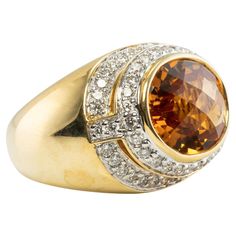 This extraordinary ring is made by New York designer Kristina. The ring is crafted in solid 18K Yellow Gold and set with genuine Earth mined Citrine and dazzling white diamonds. The center checkerboard cut Citrine measures 13mm x 10mm (5.45 carats). This is a vibrant warm yellow gem of great intensity and strong brilliance. There are 64 diamonds estimated to be VS-1 clarity and GH color for the total .80 carat. The top of the ring measures 16mm top to bottom, the setting raises 8mm high above th Dazzling Yellow Gold Rings, Luxury Brilliant Cut Topaz Ring In Yellow Gold, Luxury Yellow Gold Topaz Ring With Brilliant Cut, Luxury Yellow Gold Topaz Ring With Vvs Clarity, Luxury Brilliant Cut Yellow Gold Topaz Ring, Dazzling Yellow Gold Sapphire Ring For Formal Occasions, Elegant Yellow Signet Ring For Formal Occasions, Elegant Yellow Hallmarked Signet Ring, Luxury Yellow Gold Dome Ring With Center Stone