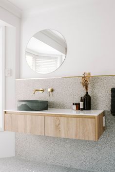 there is a sink and mirror in the bathroom with marble counter tops on both sides