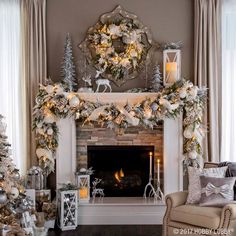 a living room decorated for christmas with white and silver decorations on the fireplace mantel