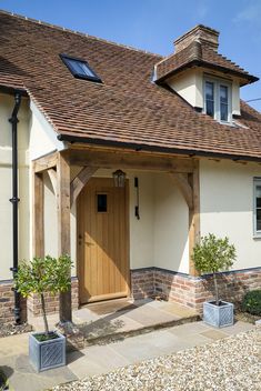 a white and brown house with a wooden door