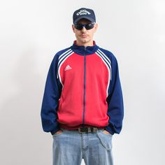 Vintage 90's Adidas tracksuit top with a front zip - in red-blue with white stripes - embroidered logo on the chest and on the back - 2 outer pockets with zipper closure - material: polyester Size from the label: USA XL, GB 46/48, D 9, F 198 MEASUREMENTS width from armpit to armpit: 27.5 inches (70 cm) length: 29 inches (74 cm) sleeve length from the neck: 32 inches (82 cm) The model is 6'1" (186 cm), measures 41-35-39 (104-88-100 cm) and typically wears clothing in size L CONDITION - 8/10 - Gre Throwback Sports Track Jacket, Red Sportswear Track Jacket For Sports Events, Red Track Jacket For Sports Events, Three Stripes Track Jacket For Sports Events, Sports Tracksuit With Three Stripes And Long Sleeves, Casual Track Jacket With Contrast Stripes For Streetwear, Sporty Red Track Jacket For Athletic Season, Red Sporty Track Jacket For Sports Season, Casual Red Track Jacket For Sports Events