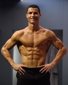 a shirtless man posing for the camera with his hands on his hips