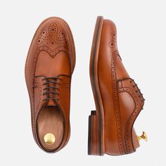 Stylish and unique. If you love the distinct look you can only get from a brogued shoe, the Royce Longwings are for you. The dramatic toe-cap swooping all the way back to the heel makes a stylish statement. Longwings pair perfectly with traditionally casual suit styles along with your favorite jeans, chinos and dress pants. Classic Brogue Lace-up Shoes For Galas, Classic Wingtip Lace-up Shoes For Derby, Timeless Wingtip Dress Shoes With Rubber Heel Cap, Classic Wingtip Leather Shoes With Perforated Toe Box, Masculine Wingtip Leather Shoes With Brogue Detailing, Wingtip Oxfords With Rubber Heel Cap For Galas, Masculine Leather Wingtip Shoes With Brogue Detailing, Masculine Almond Toe Oxfords With Brogue Detailing, Masculine Brogue Derby Shoes