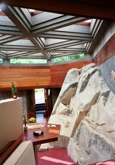 a living room filled with furniture and a large rock