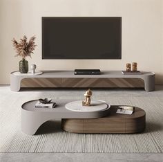 a living room with a large tv on the wall and a coffee table in front of it