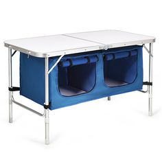 the folding table has two blue bins on it and is attached to an adjustable metal frame