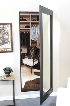 an open closet door with clothes in it