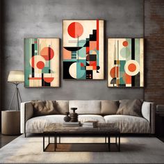 three abstract paintings hang on the wall above a couch in a living room with a coffee table