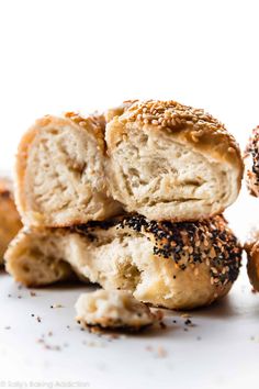 several bagels stacked on top of each other with sesame seed sprinkles