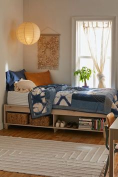 a bedroom with a bed, rug and window in it's centerpieces