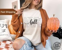 Comfort Colors® Fall Basics Shirt, Autumn Tee shirt for her, Fun Halloween Shirt Vintage Style Embrace the beauty of fall with our Charming Cute Autumn Themed Shirt! This delightful shirt features whimsical autumn graphics that capture the essence of the season, making it ideal for everything from pumpkin patch visits to cozy gatherings. Crafted from soft, breathable fabric, it offers all-day comfort and style. Pair it with your favorite jeans or leggings for a cute, casual look that celebrates White Relaxed Fit Shirt For Fall, Cute Fall Shirts, Whimsical Autumn, Fall Basics, Word Shirts, Cute Autumn, Fall Tee, Pumpkin Shirt, Fall Gifts