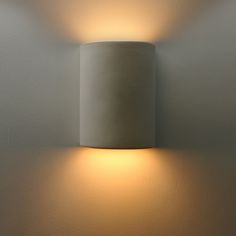 a wall light that is on the side of a wall with a dimmer in front of it