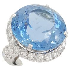 Round Cut Aquamarine & Round Cut Diamond Halo Engagement Statement/Cocktail Ring in Platinum. The ring weighs 21.8 grams, size 4-6, the flex inner ring can be adjusted, the center stone is a Natural Most Desirable Aqua Blue Color Round Cut Aquamarine weighing ~27 ct, measuring 20.23-20.16x13.49 mm. Aquamarine Cocktail Ring, Aqua Blue Color, Platinum Ring, Diamond Halo, Halo Engagement, Cocktail Ring, Round Cut Diamond, Cocktail Rings, Halo Diamond