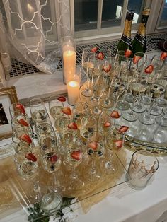 a table topped with lots of glasses filled with champagne