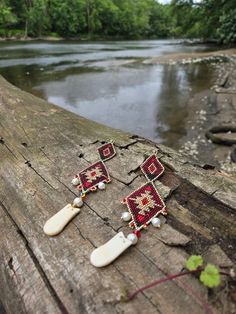 I love Native American beadwork and admire it from all tribal nations, including my own. This pair was inspired by the amazing Crow Native Peoples that use colorful beads to showcase their jewelry.  This is two tiers of brickstitch design with an Imitation Elks Tooth as the drop tied on by smoked deer hide. All earrings have either Sterling Silver  or Stainless Steel Earring Wires Need more than one pair? Please send message and I can accommodate.  Authentically Made By Potawatomi Native American Amanda Chivis  Member of The Nottawaseppi Huron Band of Potawatomi Indians  Miigwetch  (Thank you) for looking and supporting a small Native run business.  Will Ship outside of the United States. Please message me for shipping prices for your country. SHIPPING: All items are made to order please a Artisan Red Beaded Earrings For Festival, Artisan Red Handmade Beaded Earrings, Southwestern Style Handwoven Dangle Jewelry, Unique Handwoven Red Jewelry, Artisan Red Beaded Earrings, Artisan Red Earrings For Festival, Artisan Red Festival Earrings, Traditional Red Handwoven Beaded Earrings, Southwestern Red Earrings For Festival