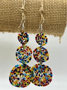 BUY ANY 2 PAIRS OF EARRINGS - We'll Add a "Surprise" Pair to Your Bag! Handmade African beaded earrings created in a truly classic style. Historically beads have been a part of the Maasai tradition, passed down from generation to generation. These conjoined circle earrings serve as a great gift, and a unique addition to your jewelry collection. Each beaded earring is an "original" work of art, individually handcrafted, no two are exactly alike which adds to their value and charm. The original na Traditional Multicolor Beaded Earrings Nickel Free, Handmade Multicolor Dangle Clip-on Earrings, Multicolor Beaded Drop Clip-on Earrings, Multicolor Beaded Clip-on Drop Earrings, Nickel Free Multicolor Beaded Round Earrings, Adjustable Multicolor Earrings With Large Beads, Multicolor Beaded Clip-on Earrings For Gift, Unique Multicolor Large Beads Earrings, Unique Multicolor Earrings With Large Beads