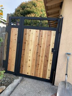 a wooden gate in front of a house