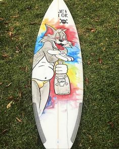 a surfboard with an image of a cat holding a beer on it's side