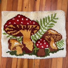 a rug with mushrooms and ferns on it