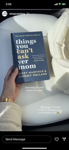 a person is holding a book in front of a white rose on a plate with the words things you can't ask mom