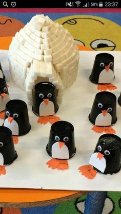 there are many penguins with hats on the table