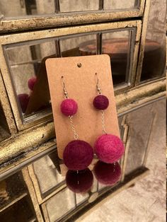 These handmade magenta and maroon needle felted ball earrings are fun and stylish and great for everyday and occasion wear! The felted balls are graduated and the colors are alternated. This product is available in other colorways in my shop. There are options for people without their ears pierced including clip-on and ear hooks. Please note that due to the handmade nature of this product, all measurements are approximate. Felted Balls, Felted Earrings, Ears Pierced, Types Of Earrings, Ball Earrings, Felt Ball, Ear Hook, Needle Felted, Needle Felting