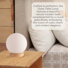 a table lamp sitting on top of a wooden night stand next to a white pillow