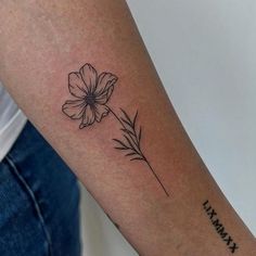 a woman's arm with a flower tattoo on the left side of her arm