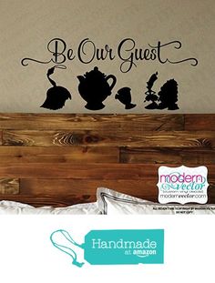 there is a bed with a wall decal that says be our guest and three teapots on it