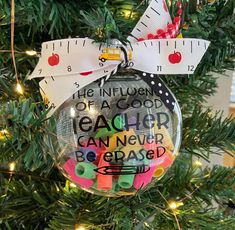 a christmas ornament hanging on a tree with a measuring tape attached to it