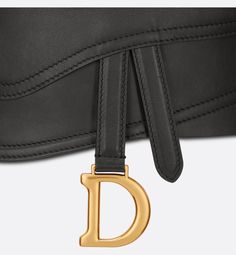 The Saddle belt honors the namesake line's hallmark codes. Crafted in black smooth calfskin, the design is embellished with a Saddle flap pocket and antique gold-finish metal D stirrup. The wide belt will embellish a skirt, dress or Bar Jacket.. Bar Jacket, Denim Swimsuit, Dior Star, Icon Shoes, Dior Book Tote, Stole Scarf, Christian Dior Couture, Short Denim, Dior Couture