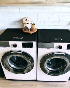 two washing machines sitting next to each other