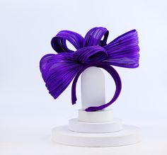 Complete your ensemble with our elegant purple silk abaca straw fascinator, featuring a comfortable headband for a secure fit. Whether you're a bridesmaid, attending a rehearsal dinner, a wedding guest, or adding flair to a cocktail party or church event, this accessory exudes elegance and adds a touch of sophistication to any occasion. Handcrafted with care, our fascinator is perfect for a myriad of events, including weddings, Christenings, cocktail parties, bachelorette parties, photo shoots, Purple Headband Fascinator For Royal Ascot, Formal Purple Headband Headpiece, Adjustable Purple Fascinator For Royal Ascot, Elegant Purple Headband For Evening, Adjustable Purple Headband For Evening, Elegant Purple Headband For Kentucky Derby, Adjustable Purple Headpiece For Formal Events, Adjustable Purple Headpiece For Evening, Adjustable Purple Mini Hat Headband