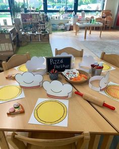 a wooden table topped with lots of paper plates