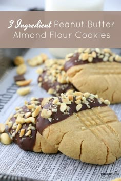 three peanut butter almond flour cookies on a baking sheet