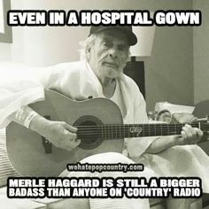 an old man sitting on a bed with a guitar in his lap and the caption reads even in a hospital gown